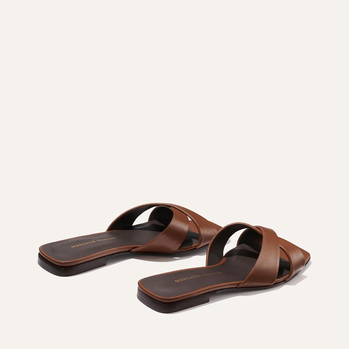 Pair of brown sandals on a white background