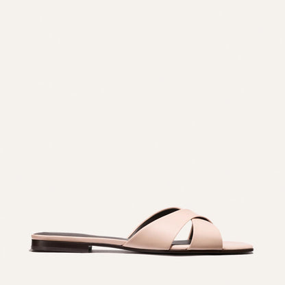 Light pink sandal with a black sole on a white background
