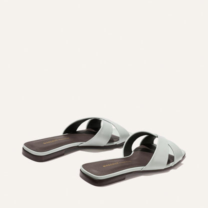 Pair of light blue sandals on a white background