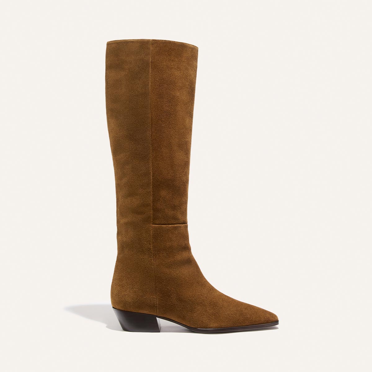 The Sierra Knee-High Boot in Cedar Suede by Margaux features a tall, knee-high silhouette crafted from brown suede, with a slight pointed toe, low angled heel, and minimal seams. It’s displayed against a plain light background.