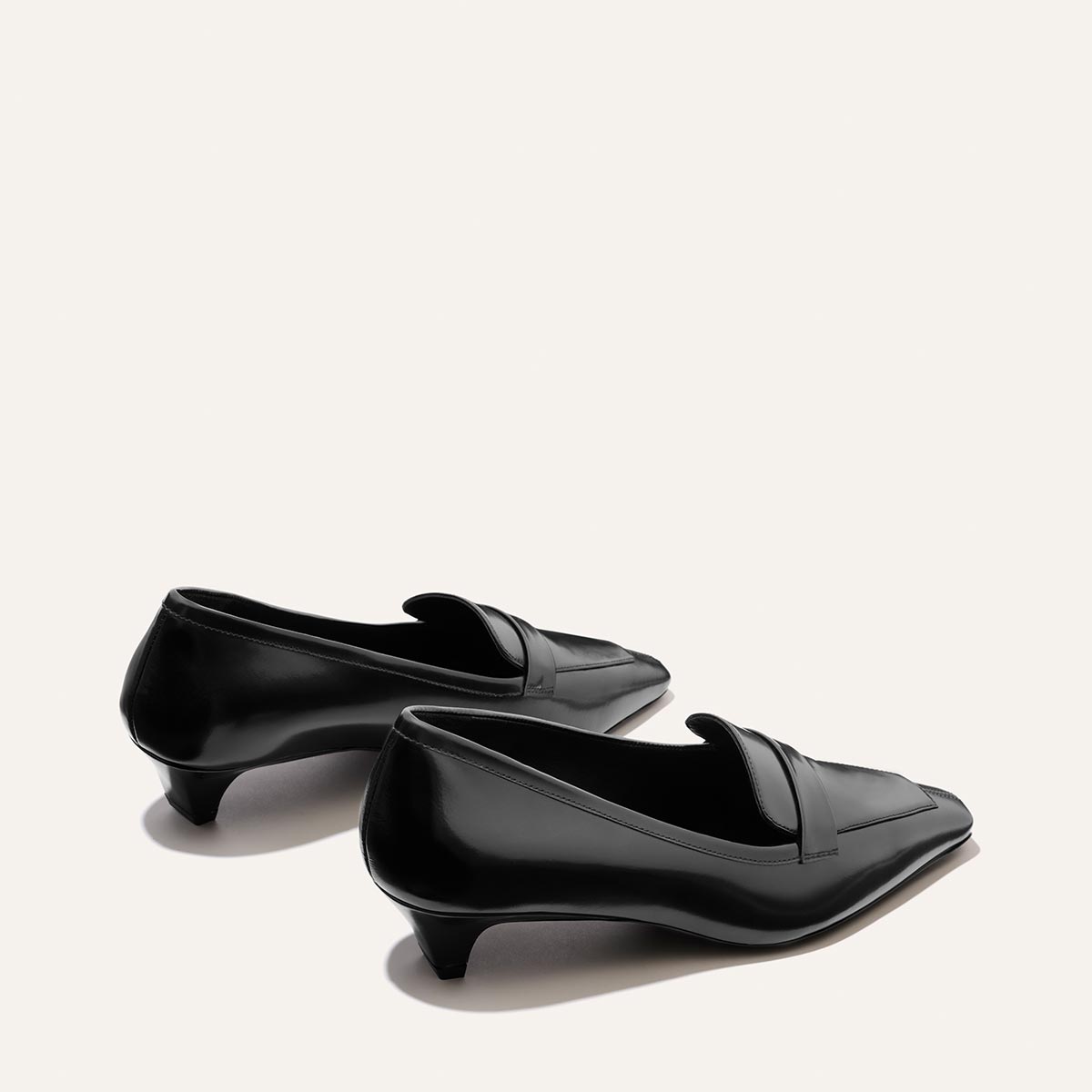 Pair of The Sigrid - Black Calf leather loafers with a low kitten heel and a squared toe.