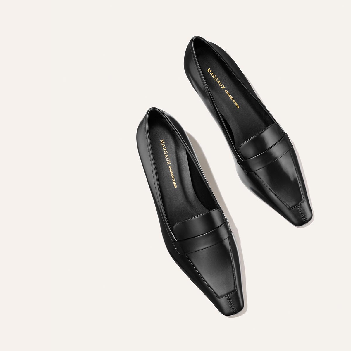 A pair of black leather Margaux The Sigrid - Black Calf loafers with square toes.