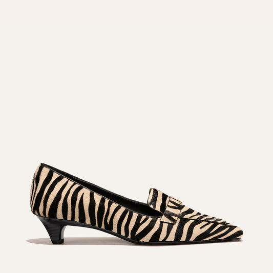 The Sigrid - Tan Zebra Haircalf pointed-toe kitten heel loafer in a tan and black zebra print pattern.