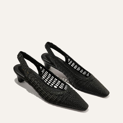A pair of black woven slingback shoes on a white background