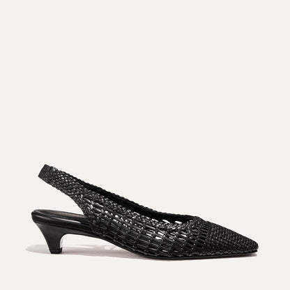 The Sofia Sling by Margaux is a black woven leather slingback pump featuring a pointed toe and low kitten heel, shown against a plain light background.