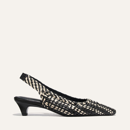 Black and white woven slingback shoe on a white background