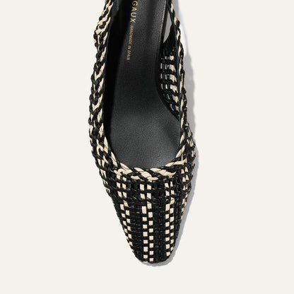 Black and beige woven shoe on a light gray background