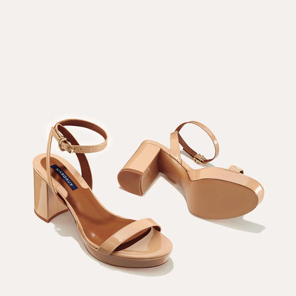 The Stella Platform in Dune Patent, featuring a sleek strap across the toes and a comfortable 3.5-inch block heel and platform.