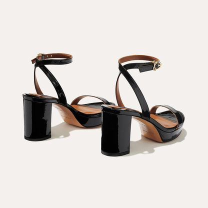 The Stella Platform in Black Patent, featuring a sleek strap across the toes and a comfortable 3.5-inch block heel and platform.
