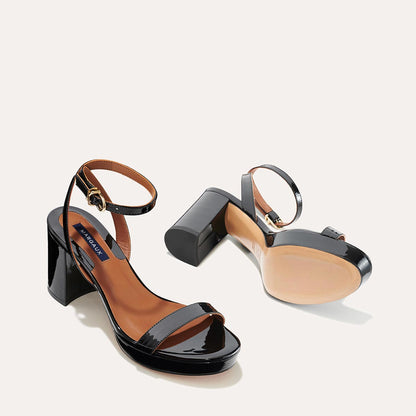 The Stella Platform in Black Patent, featuring a sleek strap across the toes and a comfortable 3.5-inch block heel and platform.