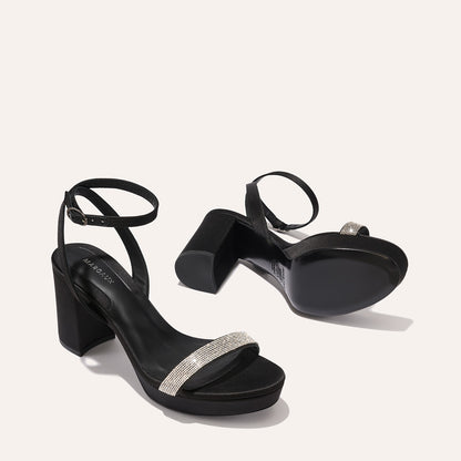 The Stella Platform in Black Satin with Crystals, featuring a sleek strap across the toes and a comfortable 3.5-inch block heel and platform.