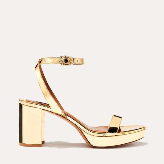 Margaux's classic and comfortable Stella Platform in shiny gold patent leather with a perfectly placed strap and a walkable block heel