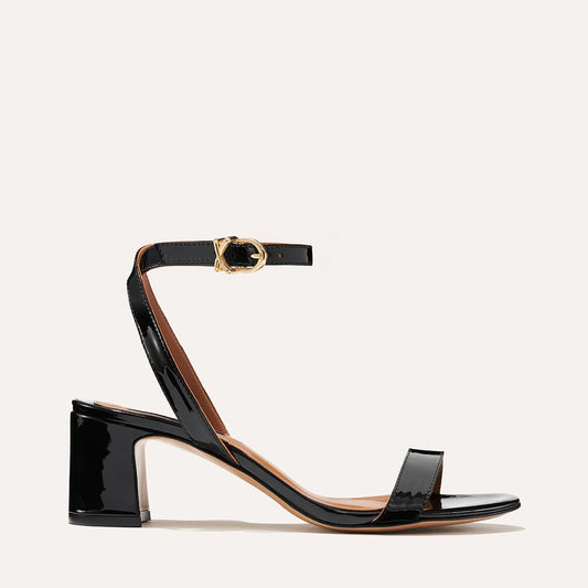 Margaux's classic and comfortable Stella Sandal in shiny black patent leather with a perfectly placed strap and a walkable block heel