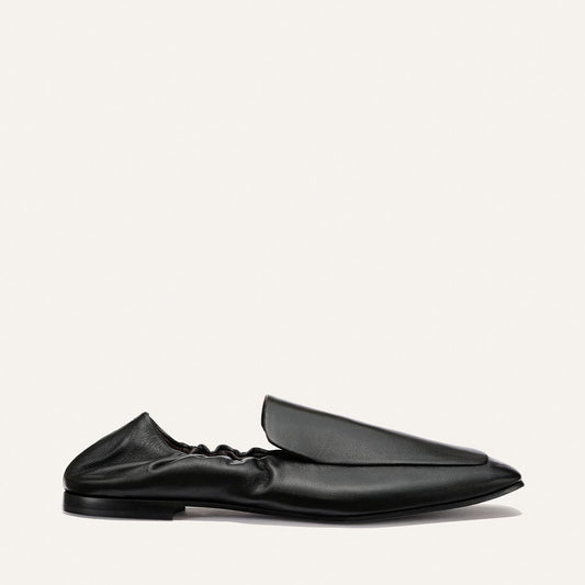 The Studio Loafer - Black Nappa by Margaux, featuring a pointed toe and a distinctive gathered ruched back, is displayed in profile against a plain white background.