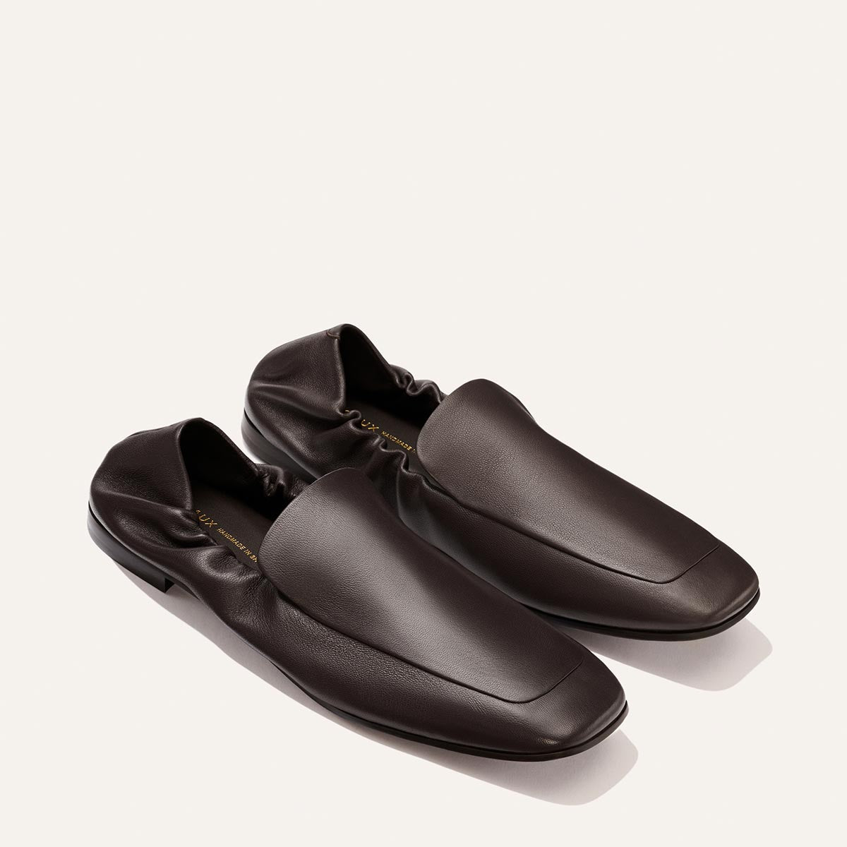 The Studio Loafer - Espresso Nappa by Margaux, featuring dark espresso brown leather, a soft gathered heel, and square toes, is displayed on a plain light background.