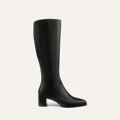 The Uptown Boot - Black Calf by margaux-development is a black knee-high leather boot with a round toe and chunky mid-height heel, shown against a plain light background.