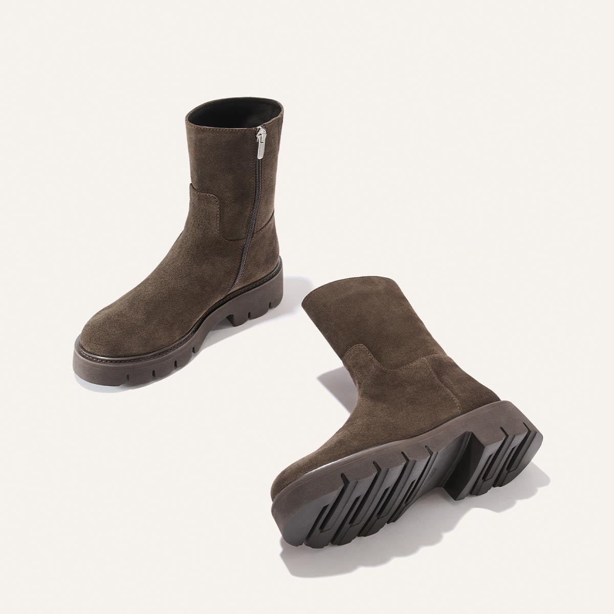 The Wells Boot - English Brown Suede ankle boots featuring side zippers and thick, lugged rubber soles.