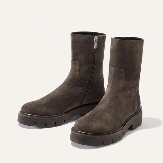 The Wells Boot - English Brown Suede ankle boots feature a side zipper, a chunky lugged sole, and a lightweight design perfect for travel.