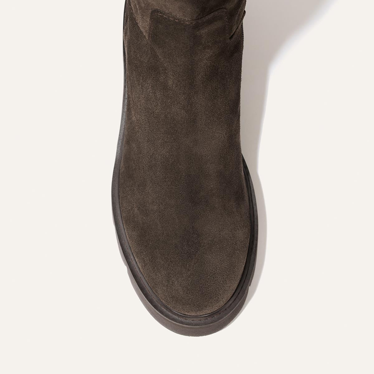 Top-down view of The Wells Boot - English Brown Suede, a dark brown suede all-weather boot with a rounded toe and a lightweight, thick rubber sole.