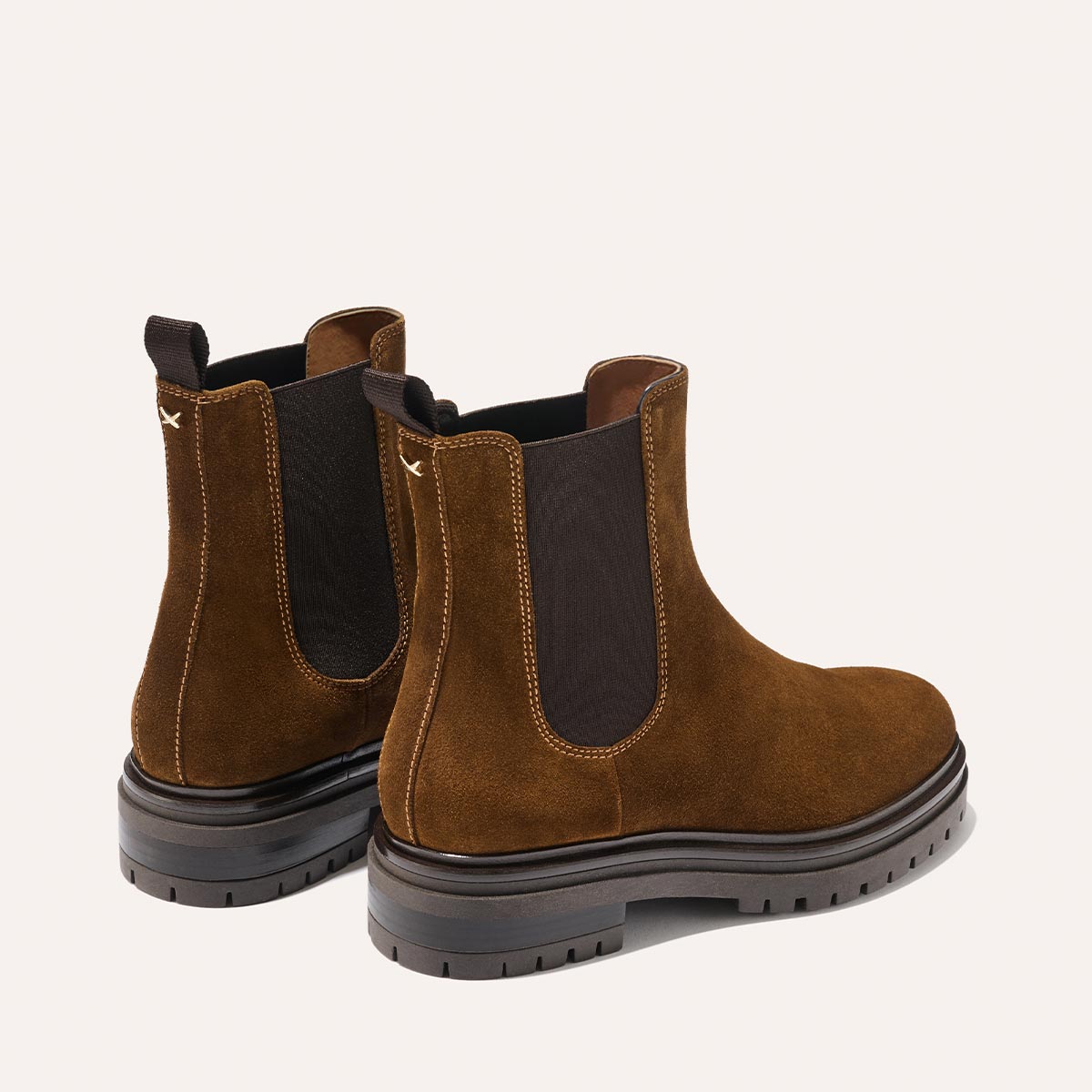 The Margaux West Chelsea Boot in Cedar Suede is a water-resistant brown Italian suede boot with black elastic side panels, pull tabs, and a durable lug sole, shown on a light background.