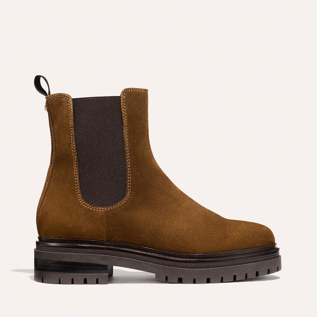 The West Chelsea Boot - Cedar Suede by Margaux is a brown Italian suede boot with black elastic side panels, a back pull tab, and a durable lug sole, shown in side view on a light background.