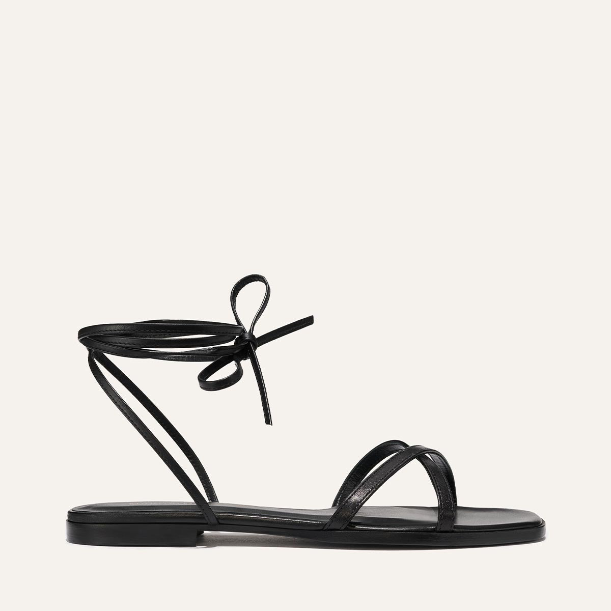 Black sandal with a bow on a white background