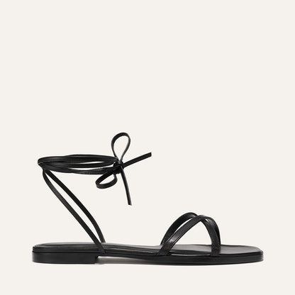 Black sandal with a bow on a white background