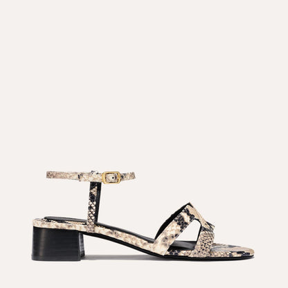 Low heeled sandals shown in natural embossed python