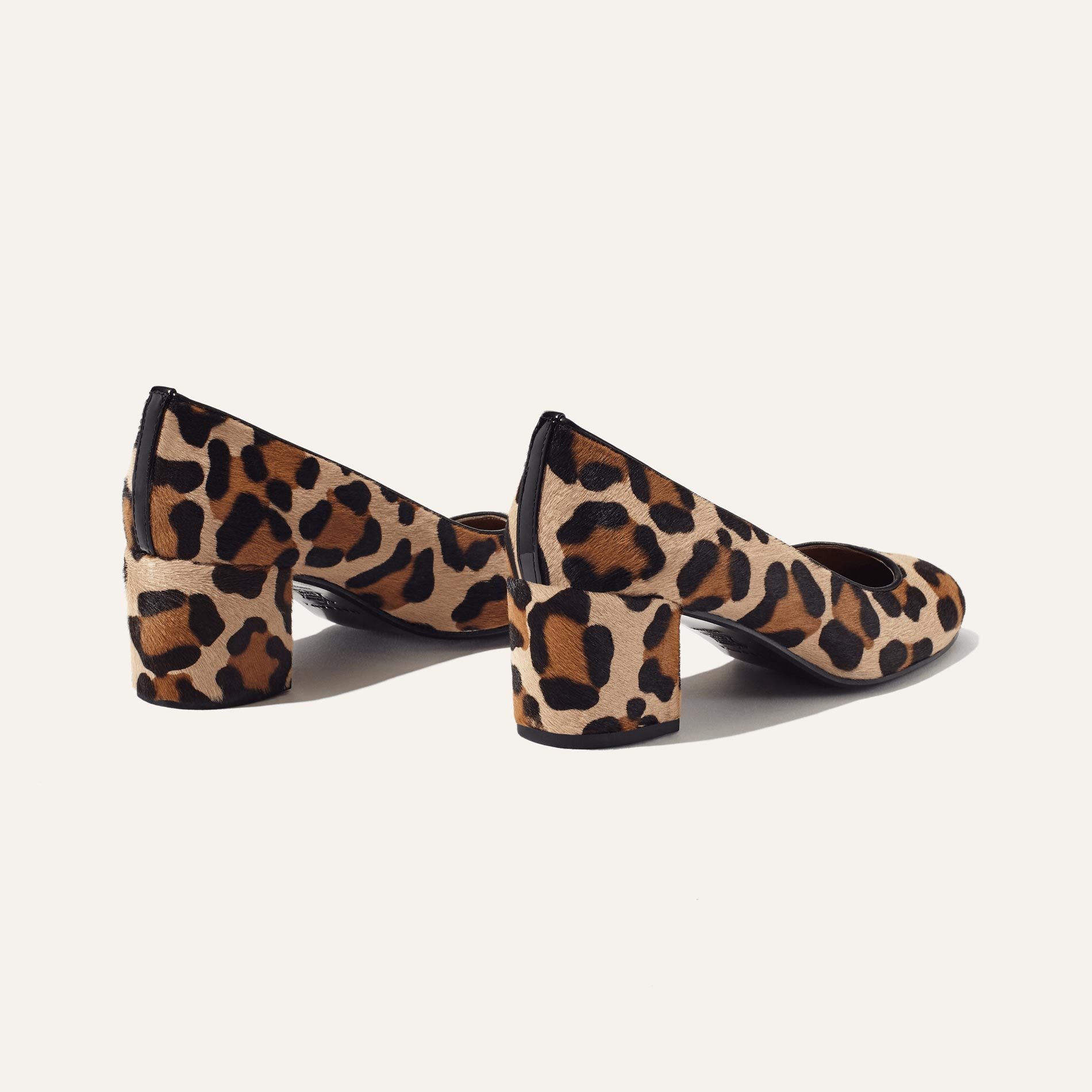 The Heel - Tan Leopard Haircalf by Margaux: a pair of women’s block heel shoes in brown and black leopard print, shown on a plain white background.