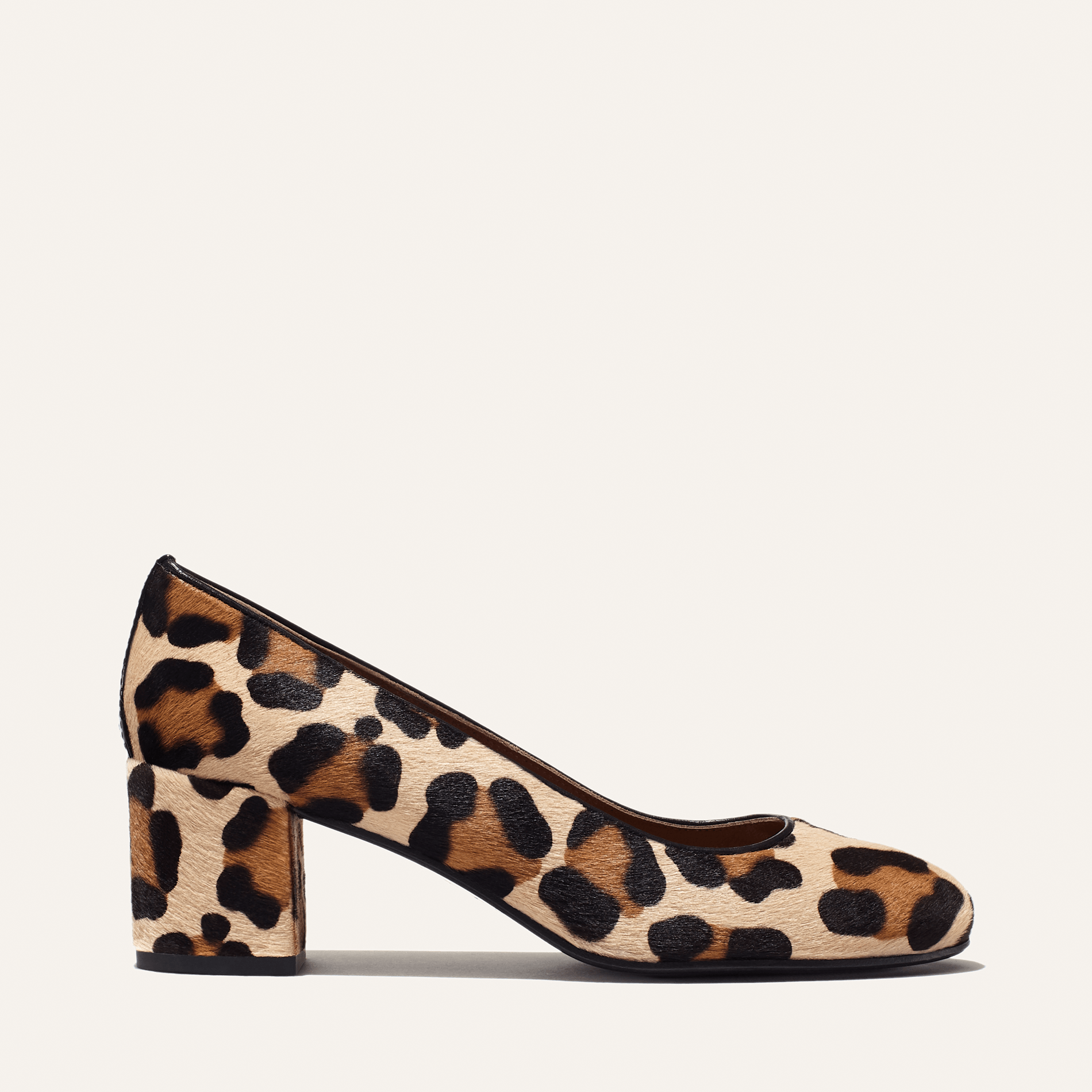 The Heel - Tan Leopard Haircalf by Margaux is a women’s block-heeled shoe with a rounded toe, featuring an elegant tan, brown, and black leopard print and a sturdy mid-height heel.