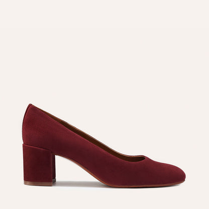The Heel in Burgundy Suede, a classic block heel featuring a sleek almond toe design complemented by a comfortable 2.5-inch heel.