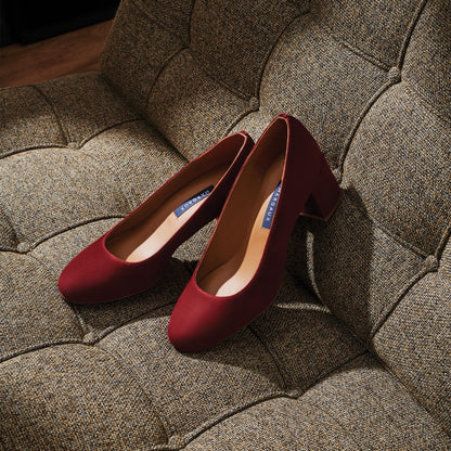 The Heel in Burgundy Suede, a classic block heel featuring a sleek almond toe design complemented by a comfortable 2.5-inch heel.