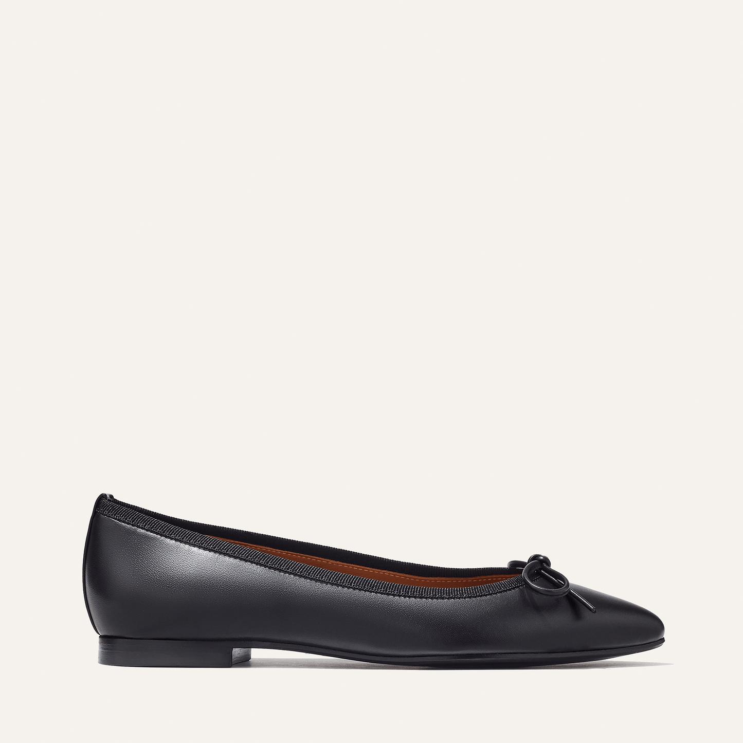 The Pointe in Black Nappa, a classic and comfortable ballet flat featuring a refined pointed toe design and decorative bow. 