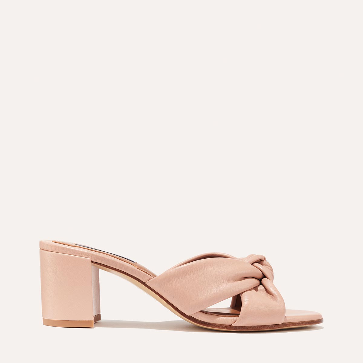 Margaux's Carmine Mule in nude pink nappa leather with a knot detail and comfortable block heel