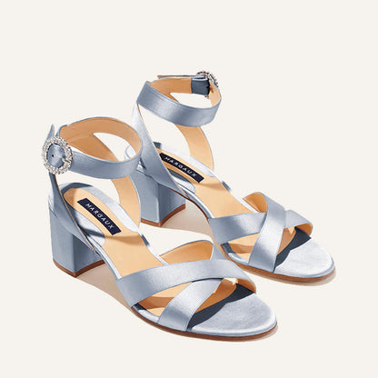 The City Sandal by margaux-development features powder satin, open toes, crisscross and ankle straps with crystal buckles, a cushioned insole for comfort, and the Margaux logo on the tan footbed.