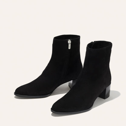 The Downtown Boot in Black Suede, a chic ankle-height design complete with a Western-inspired welt and a comfortable 2.5-inch stacked heel.