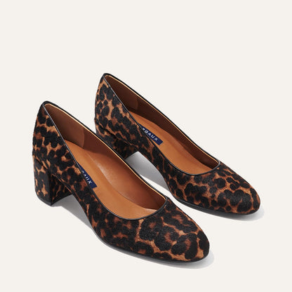 The Heel in Chocolate Leopard Haircalf, a classic block heel featuring a sleek almond toe design complemented by a comfortable 2.5-inch heel.