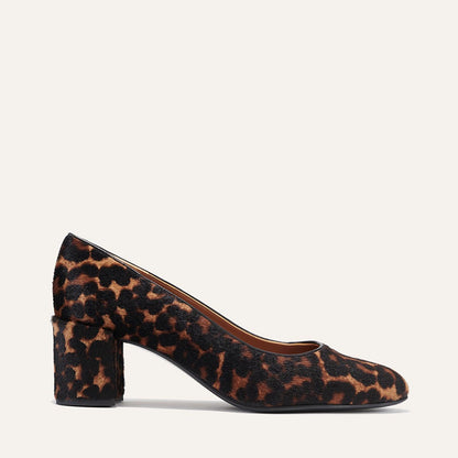 The Heel in Chocolate Leopard Haircalf, a classic block heel featuring a sleek almond toe design complemented by a comfortable 2.5-inch heel.