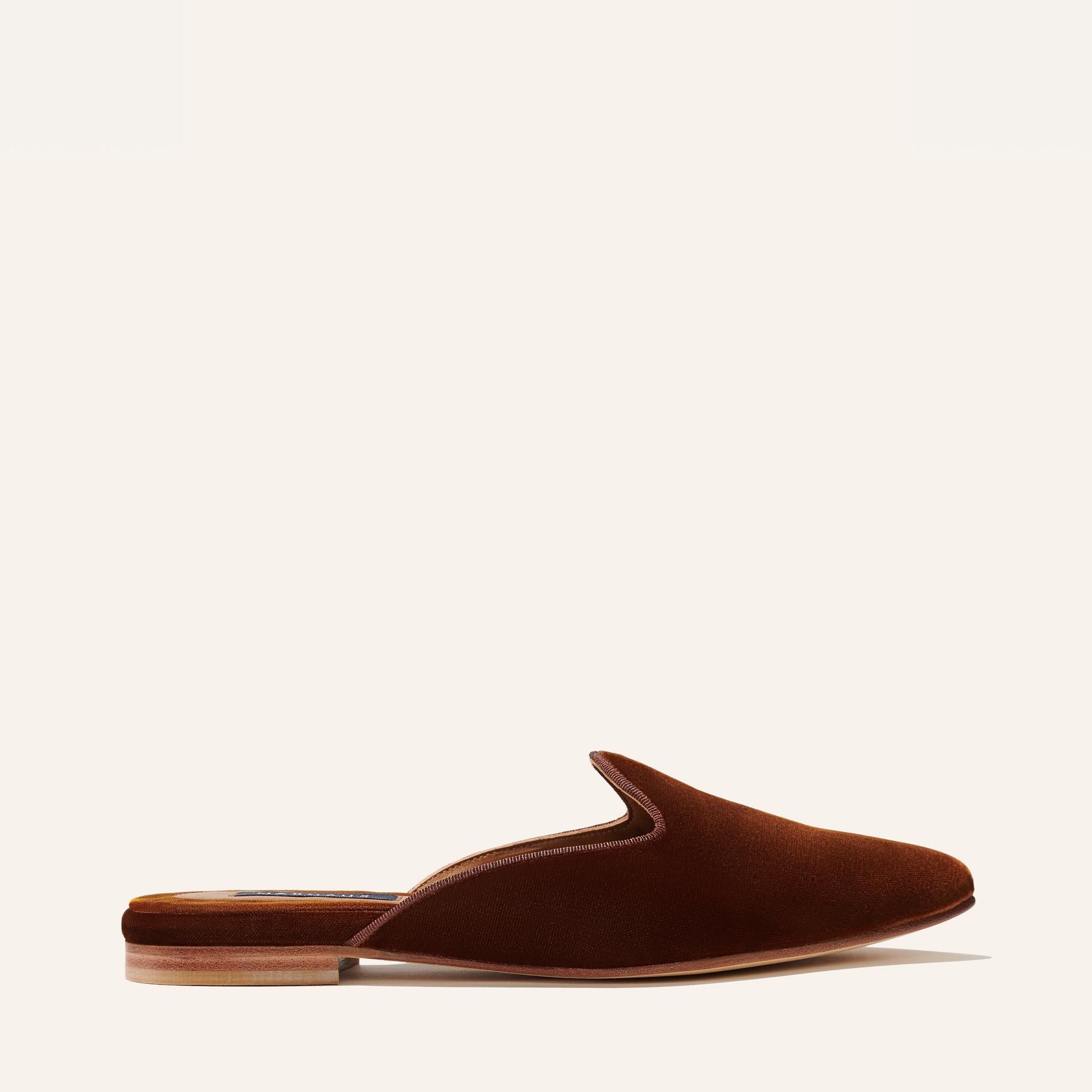 The Mule - Rust Velvet by Margaux is a comfortable slip-on with a closed toe, open back, and low wooden heel in rich velvet, shown in side view against a light background.