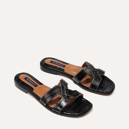 The MX Sandal in Black, a slip-on sandal featuring croc-embossed Italian calf leather with structured straps and a subtly square toe.