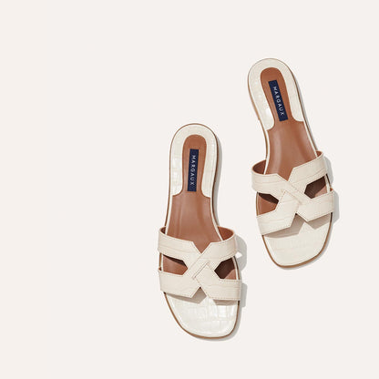 The MX Sandal in Cream, a slip-on sandal featuring croc-embossed Italian calf leather with structured straps and a subtly square toe.