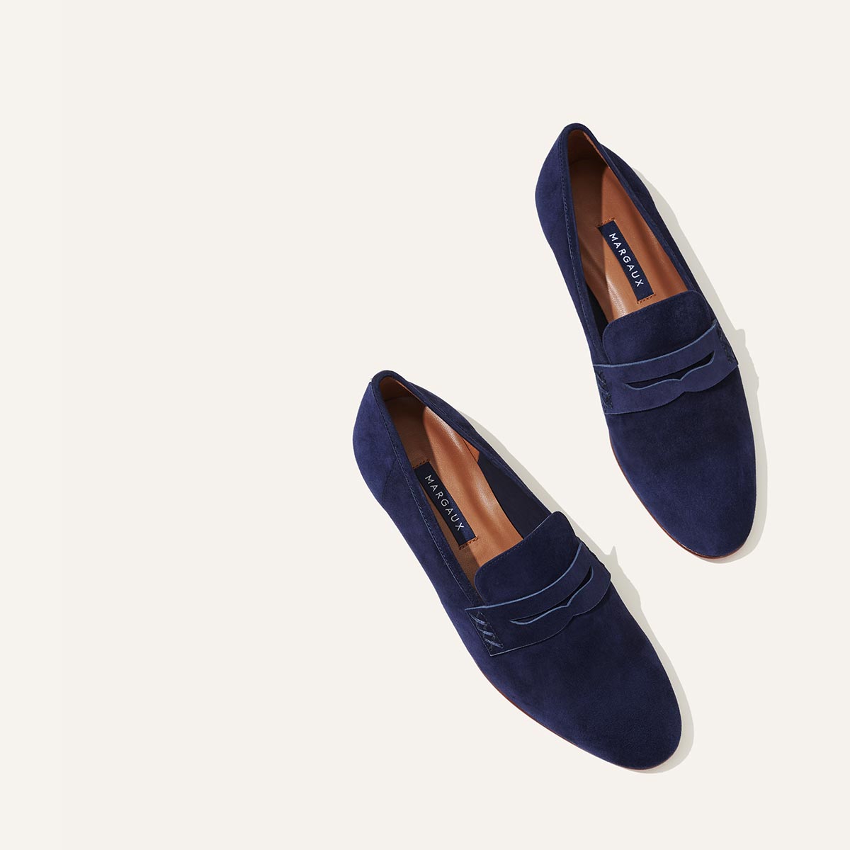 Margaux's classic and comfortable Penny loafer, made in Spain from soft, navy blue Italian suede 