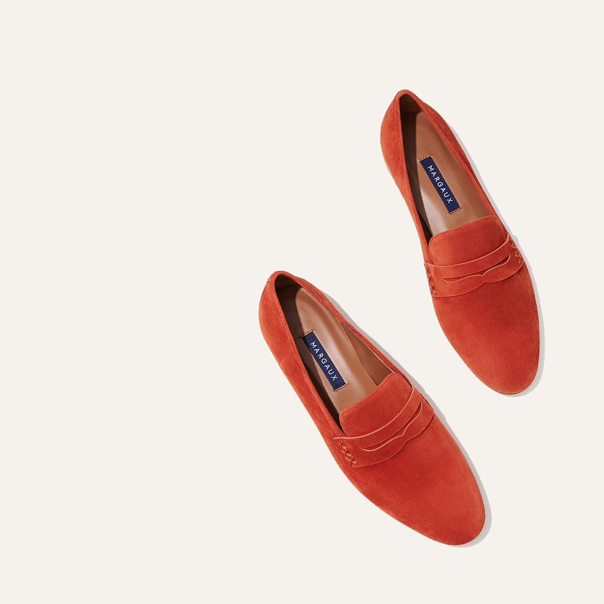 Margaux's classic and comfortable Penny loafer, made in Spain from soft, orange Italian suede 