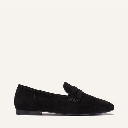 The Penny Loafer in Black Suede, featuring an ultra-luxe Italian suede upper with an unlined construction for a glove-like fit.