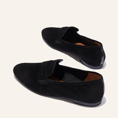 The Penny Loafer in Black Suede, featuring an ultra-luxe Italian suede upper with an unlined construction for a glove-like fit.