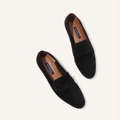The Penny Loafer in Black Suede, featuring an ultra-luxe Italian suede upper with an unlined construction for a glove-like fit.