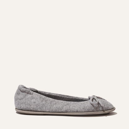 The Slipper - Heather by Margaux is a grey ballet flat with a small bow and plush quilted innersole for comfort, shown on a light background.
